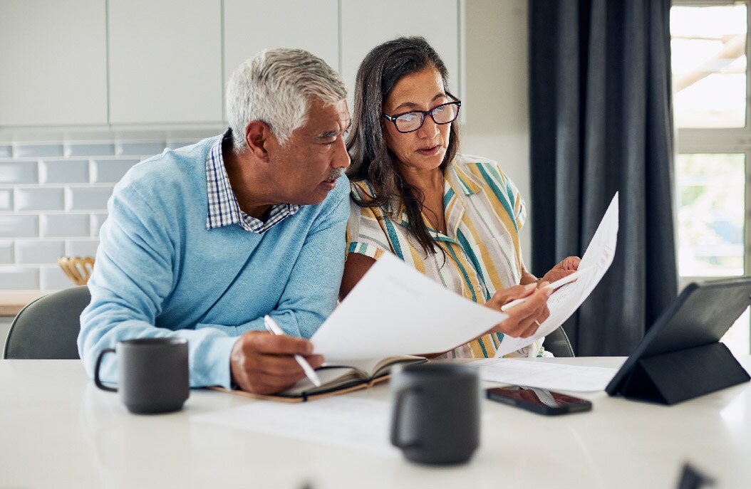 Two people looking at paper work