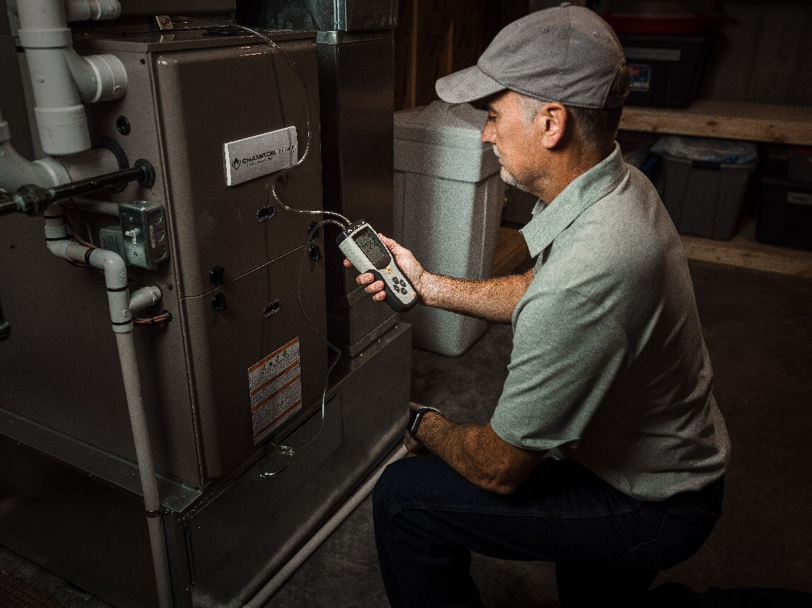Maintenance technician looking at HVAC unit
